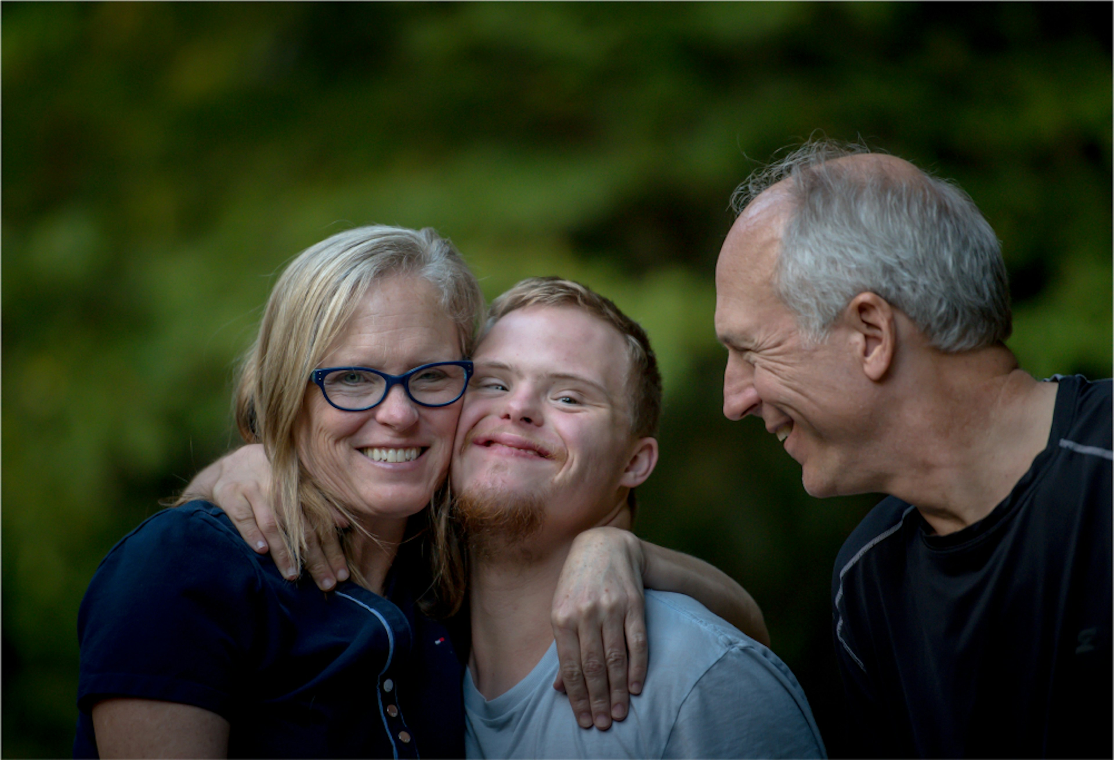 Client and Family Advocate: Family smiling together outside.