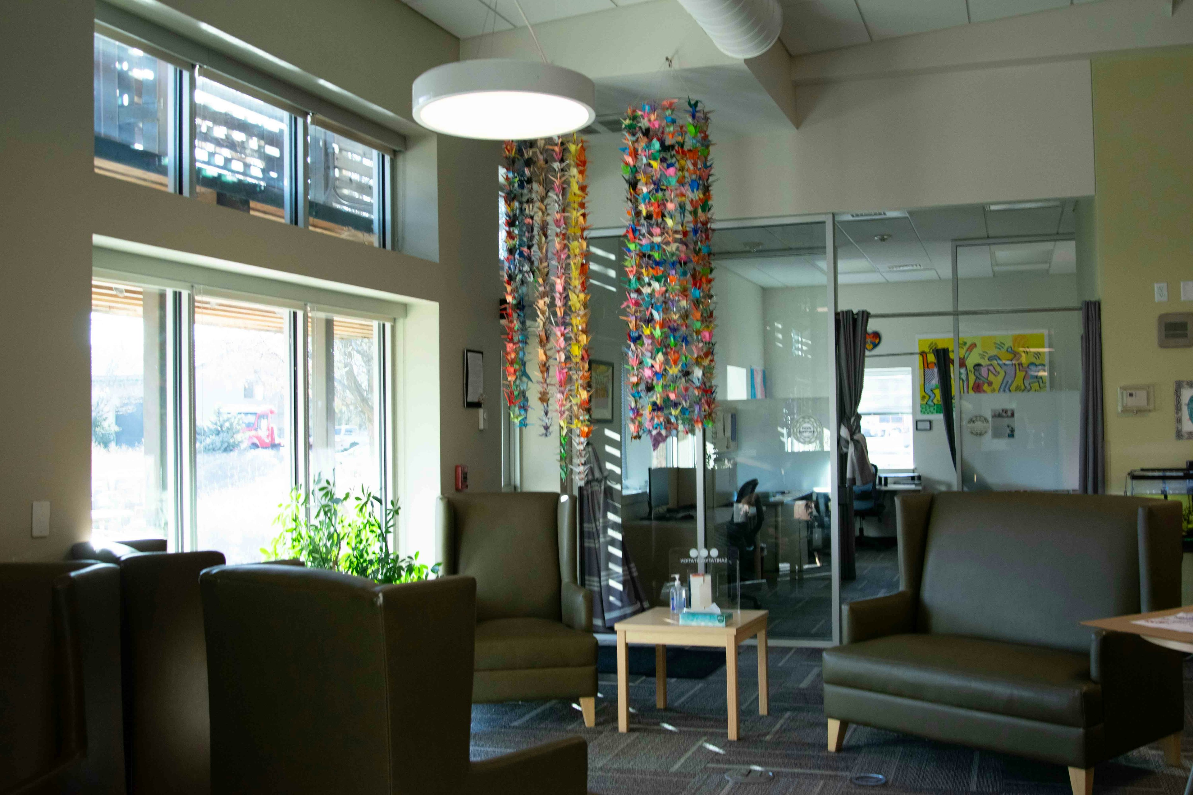 Wellness Center lobby featuring chairs and couches and bird origami art. 