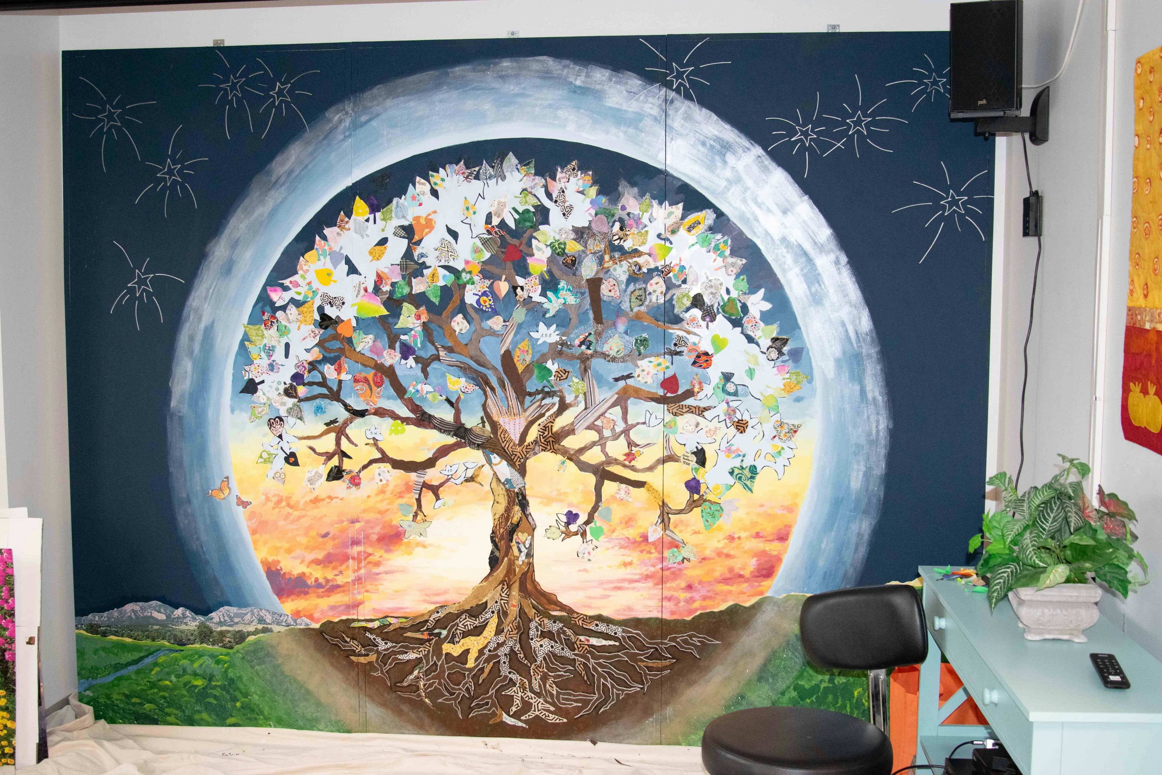 Tree mural tapestry featuring colorful leaves and intricate roots.