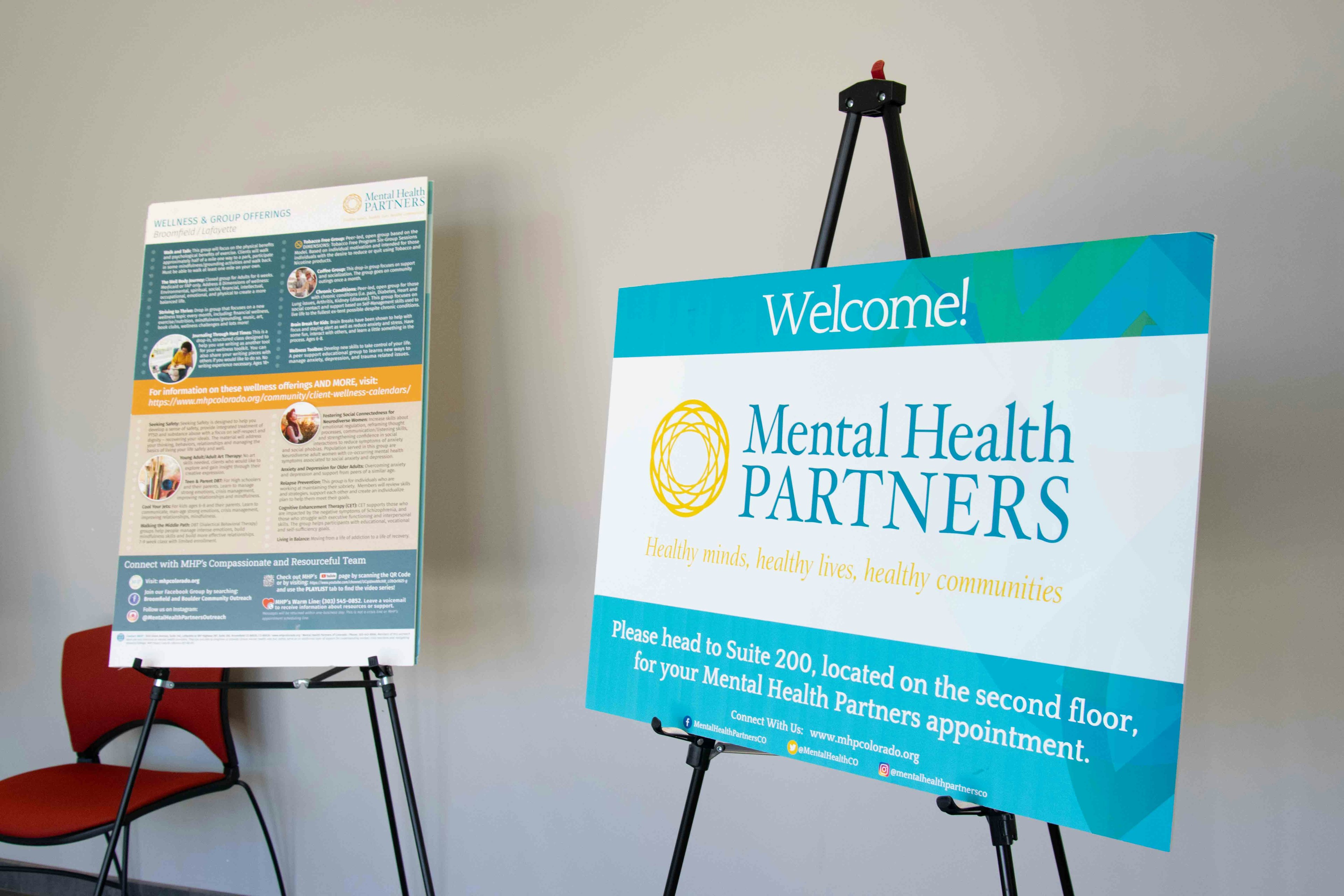 Entry of Broomfield offices with large posters that display Mental Health Partners organization information.