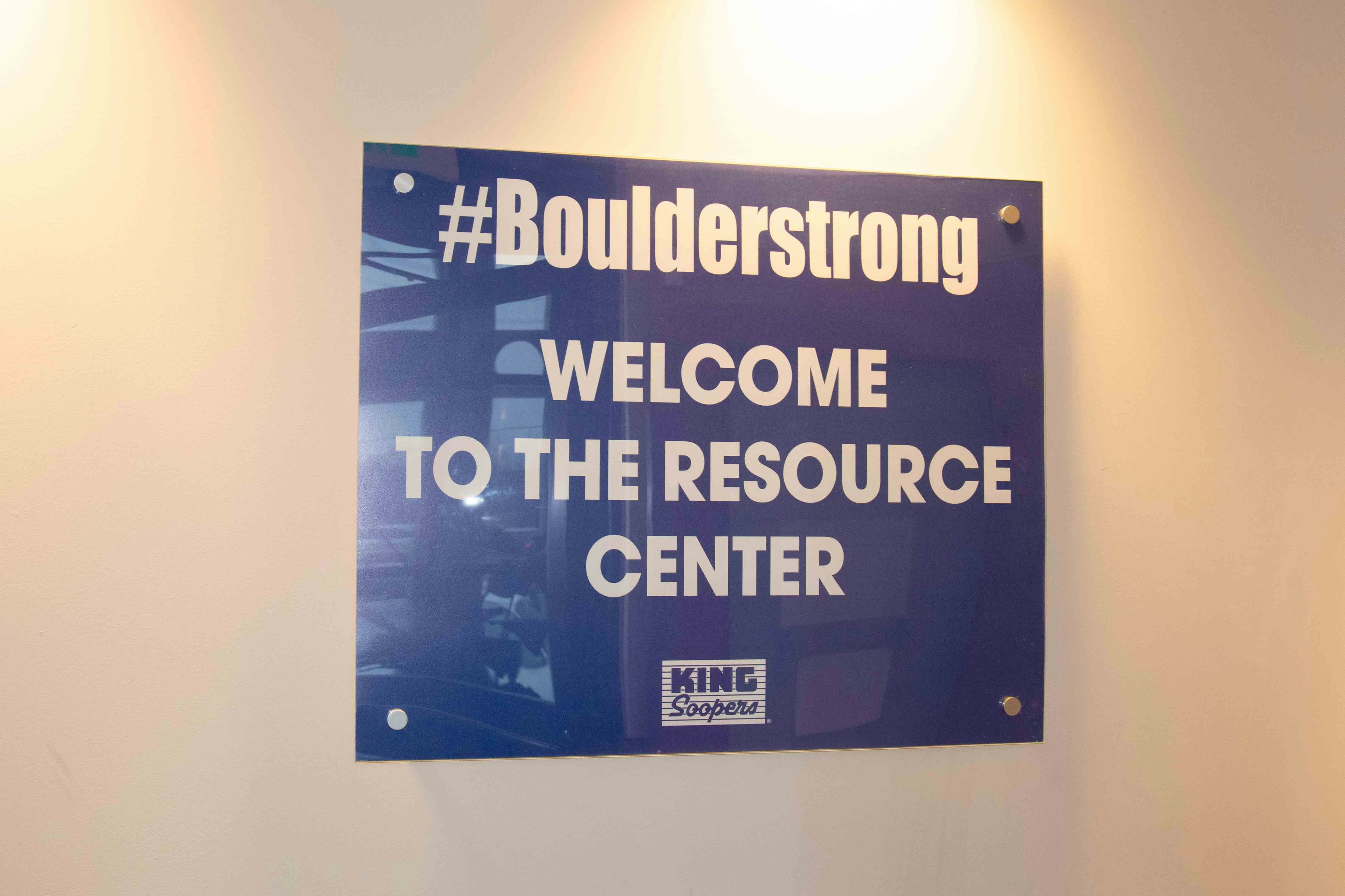 Black sign with white font that reads: #Boulderstrong Welcome to the Resource Center