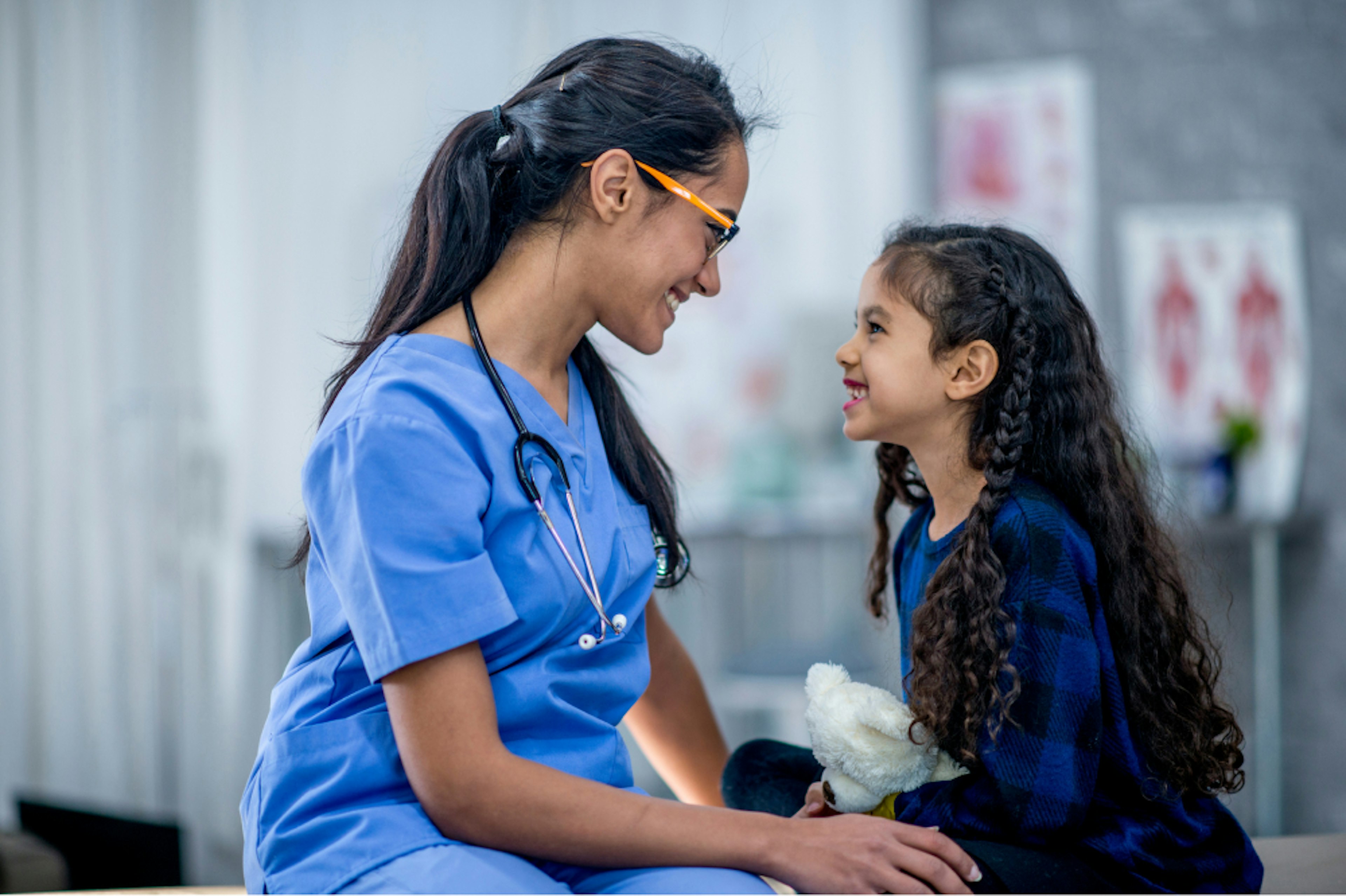 Medical & Nursing Services Tile: Nurse talking to young girl.